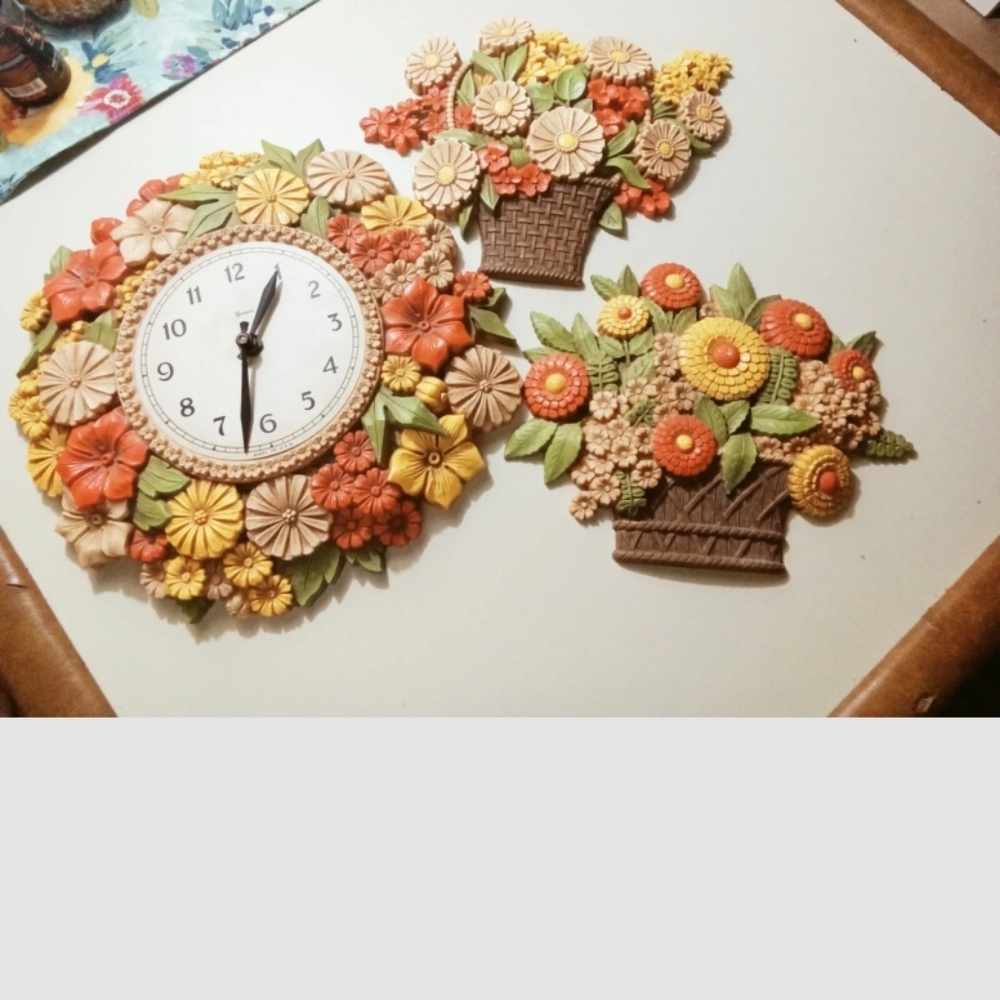 Vintage'70s era clock flower set hangs on the wall.  Set of three